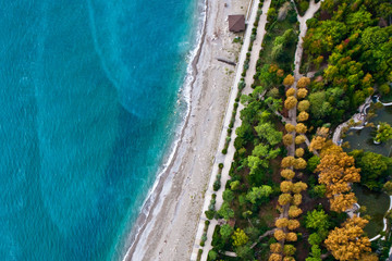 Top-down (Flat lay) view of the beach and the blue (turquoise) sea, sea holidays - bright, vibrant life;