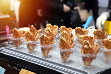 Close up Fried dough using fish shaped molds Serve in a clear plastic glass. Sold as street food in Seoul South Korea
