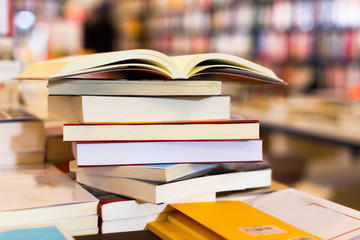 different books lying on table in library