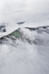 Over the forest hills. Flying above the clouds (sea of clouds) foggy view from a great height Aerial view from a height in in Abkhazia