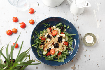 Vegetarian salad with tofu, cherry tomatoes, arugula, cucumber.