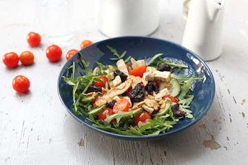 Vegetarian salad with tofu, cherry tomatoes, arugula, cucumber.