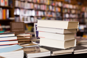 stack of books lying on table in bookstore
