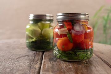 Preservation, pickles, cucumbers and tomatoes in a jar