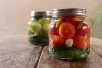 Preservation, pickles, cucumbers and tomatoes in a jar
