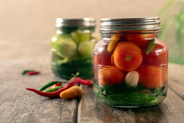 Preservation, pickles, cucumbers and tomatoes in a jar