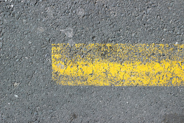 Asphalt surface texture detail with old parking yellow paint