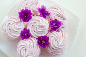 Нomemade marshmallow with violets on a plate