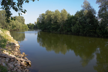  Reflection on the water surface of a serene river with paths of light. Glare.