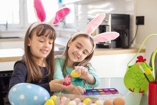 Children coloring eggs for Easter celebration 