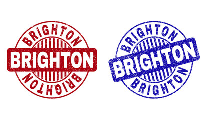 Grunge BRIGHTON round stamp seals isolated on a white background. Round seals with grunge texture in red and blue colors. Vector rubber overlay of BRIGHTON caption inside circle form with stripes.