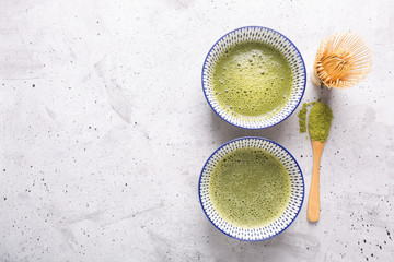 Top view of green tea matcha in a bowl on concrete surface