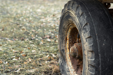lattened rusty dirty wheel of an old abandoned car