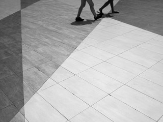 black and white people walk on street floor