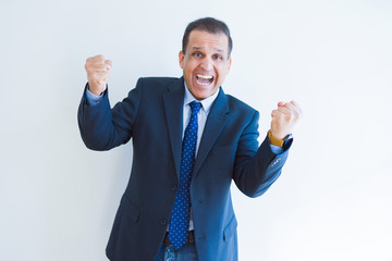 Middle age business man celebrating and screaming happy for succesful win