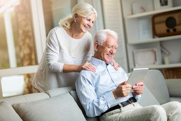 Senior couple using digital tablet at home
