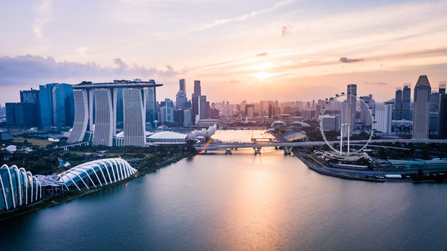 Drone aerial picture of the skyline of Marina Bay in Singapore during sunset
