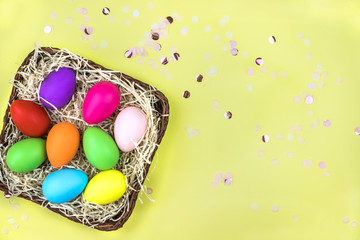 Colored Easter eggs in the basket. Flatlay.