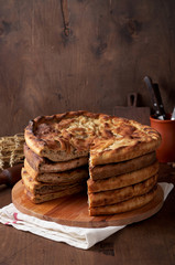Various Traditional Ossetian meat pies with beef, chicken and salmon on a wooden background