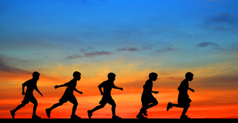 Fototapeta na wymiar silhouette young boy running on sunset