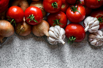 Ripe fresh harvested vegetables on table. Onions, tomatoes, garlic, pepper. Making delicious vegetarian meal or canning veggies for winter in jars. Concept of healthy eating