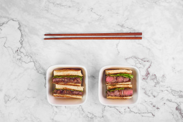 sandwich katsu sando with beef. wagyu katsu. japanese cuisine traditional food. Trendy fast food at marble background
