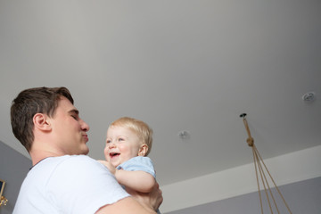 A child plays with a modern father in the nursery.
