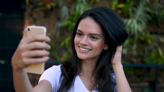 Slow motion  shot of beautiful girl taking selfie