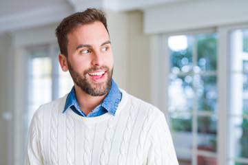 Handsome man smiling positive at the camera