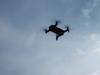 Drone hovering inthe morning blue sky