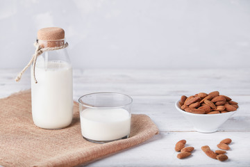 Glass of almond milk on the wooden table 