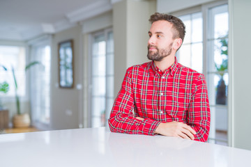 Fototapeta premium Handsome man wearing colorful shirt smiling looking side and staring away thinking.