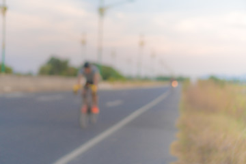 Obraz premium People ride bicycle in evening with sunset and sunlight.