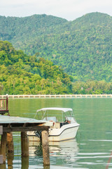  Beautiful landscape of Thailand, white boat on the water near the pier
