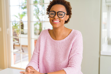 Beautiful young african woman with afro hair wearing glasses