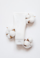 Natural organic cosmetic packaging plastic mock up with cotton flowers. Mock-up bottle for branding and label.