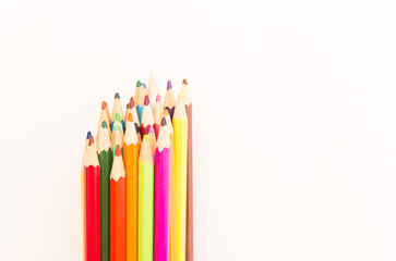 multi-colored pencils for drawing children in school and kindergartens on a white background