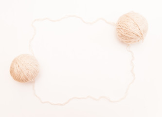 a ball of beige or white wool for knitting and hobbies on a white background