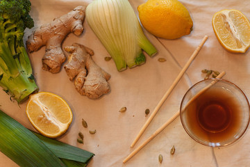  Asian cuisine ingredients over concrete background, top view, copy space, square crop. Flat vegetables, lemon, spices and soy sauces for cooking Vietnamese, Thai or Chinese dishes. Healthy and Veggie
