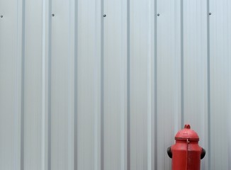 fire hydrant on street floor with metal sheet wall