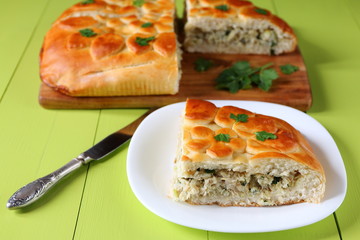 Freshly baked fish pie on a green wooden table.