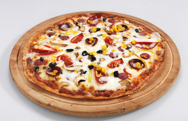 Pizza with tomatoes, mushroom, sausages, cheese and corn.