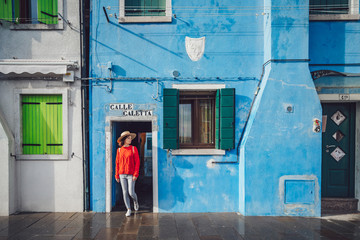 Attractive girl in a red sweater in Burano