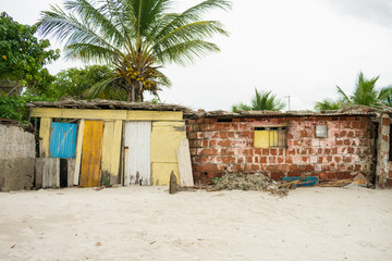 Poorly built shacks by the beach on Itamaraca Island (Pernambuco, Brazil)