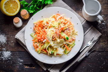 Salad of fresh cucumbers, carrots, lettuce, onions and chicken.