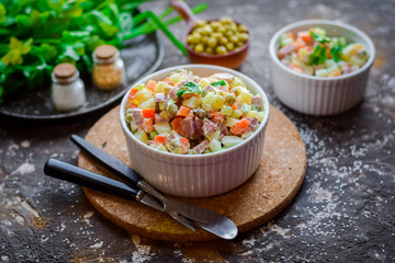 Salad Olivier with fresh cucumbers.