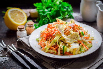 Salad of fresh cucumbers, carrots, lettuce, onions and chicken.