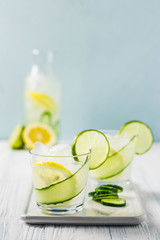 Refreshing summer drinks, iced cucumber lime cocktail. Selective focus, space for text.