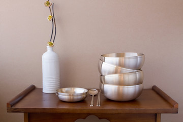 Korean high quality brass tableware on the wooden table. 