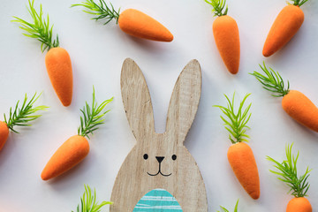 Wooden easter bunny with orange carrots